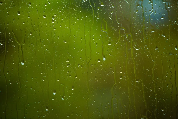 Primer plano de las gotas de agua sobre el vidrio como fondo — Foto de Stock