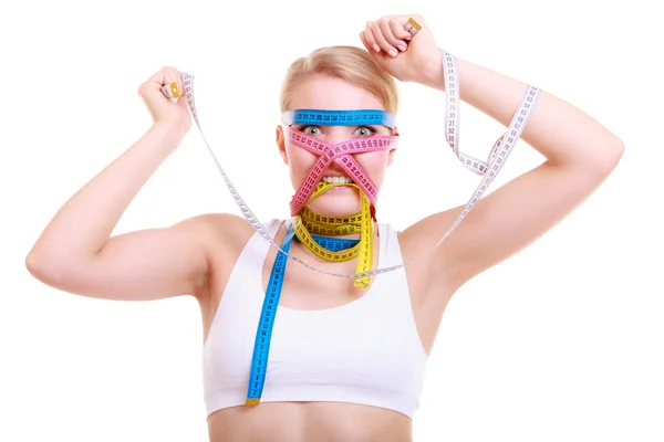 Woman with a lot of colorful measure tapes — Stock Photo, Image