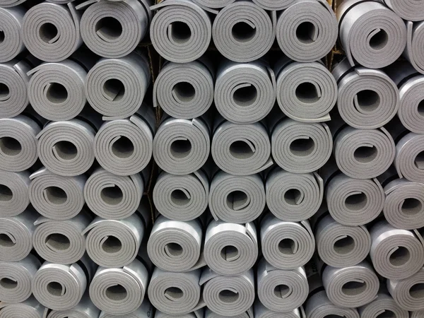 Rolled up gray foam mats — Stock Photo, Image