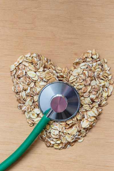 Oat flakes and stethoscope. — Stock Photo, Image