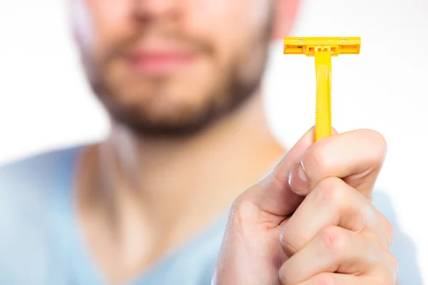 Young man showing razor blade — Stock Photo, Image