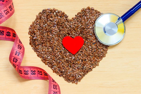 Raw flax seeds  and stethoscope — Stock Photo, Image