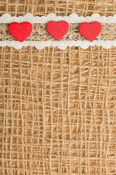 Red hearts on cloth — Stock Photo, Image