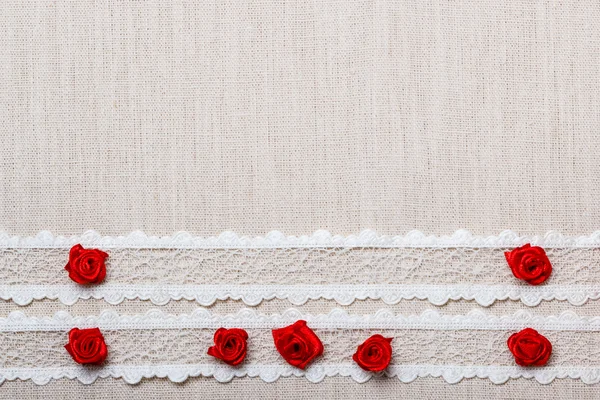 Red silk roses on cloth — Stock Photo, Image