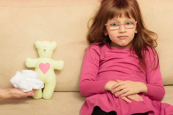 Girl sitting on sofa — Stock Photo, Image