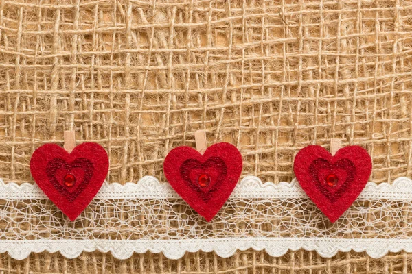 Red hearts on cloth — Stock Photo, Image