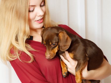 Woman holding  dog clipart