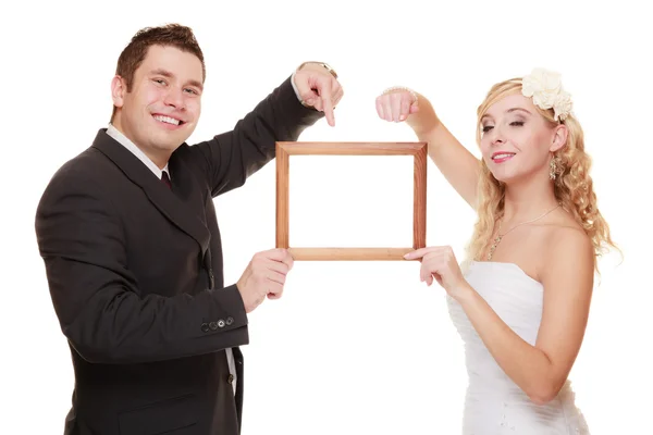 Couple pointing empty frame — Stock Photo, Image