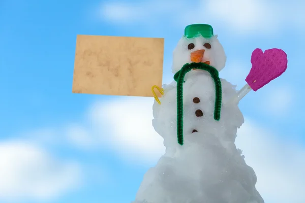 Muñeco de nieve de Navidad con tarjeta de papel — Foto de Stock