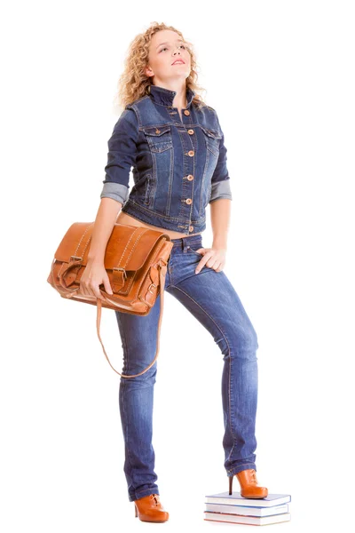 Girl in blue jeans holding bag — Stock Photo, Image