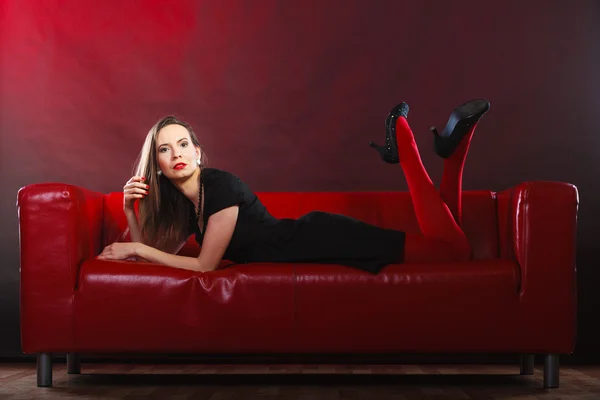 Woman relaxing on couch — Stock Photo, Image