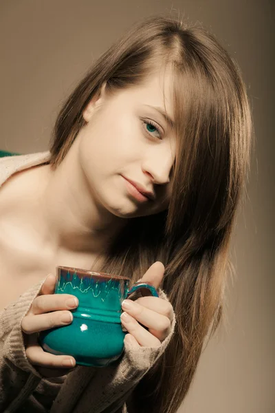 Girl holding cup of hot drink — Stock Photo, Image