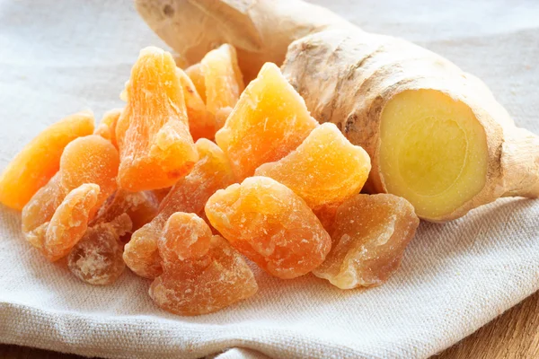 Root and candied ginger on rustic table — Stock Photo, Image