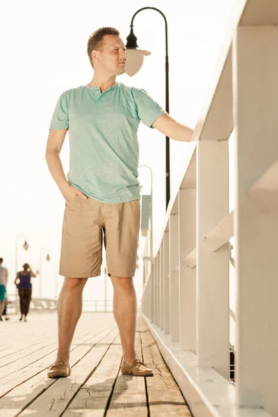 Handsome man standing on pier — Stock Photo, Image