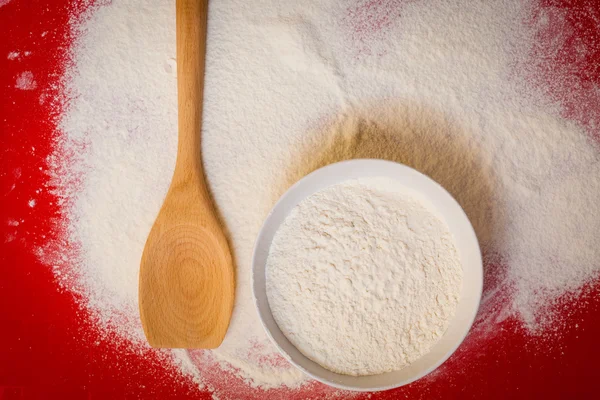Wheat flour on red silicone mat — Stock Photo, Image