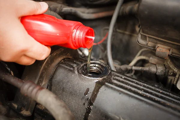 Mekaniker hälla olja i motor. — Stockfoto