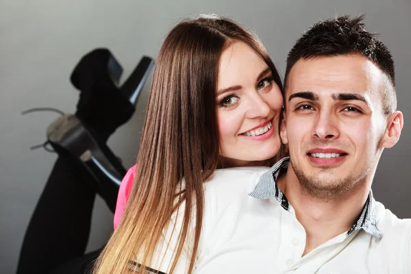 Smiling young couple portrait on gray — Stock Photo, Image