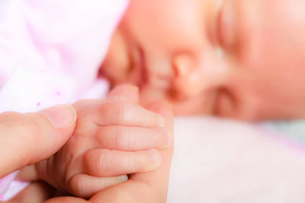 Hand de slapende babymeisje in de palm van moeder — Stockfoto