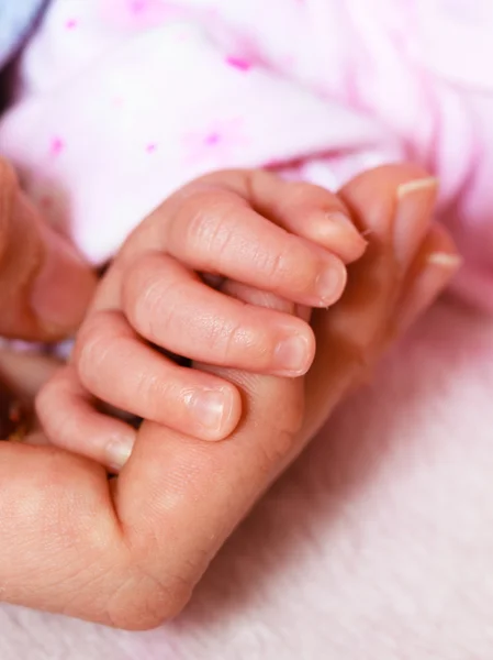 Closeup newborn baby holding his mothers finger — Stock Photo, Image