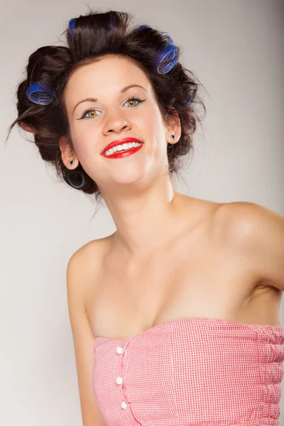 Girl in hair curlers on gray — Stock Photo, Image