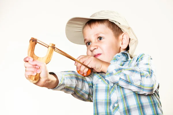Kid holding slingshot in hands — Stock Photo, Image