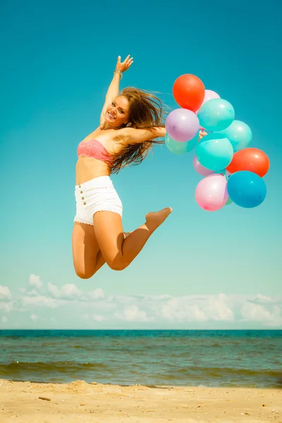 Ragazza che salta con palloncini — Foto Stock