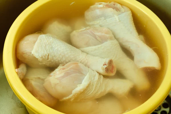 Raw chicken meat drumstick in water — Stock Photo, Image