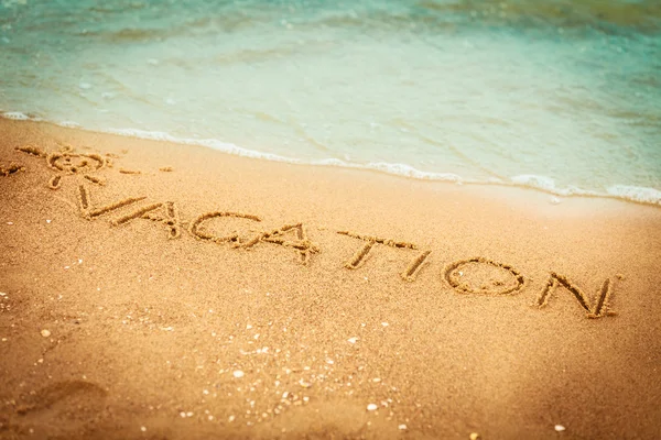 Vacation written in the sand — Stock Photo, Image