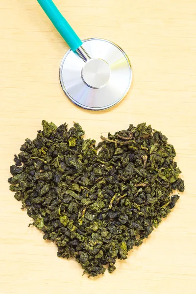 Hojas de té verde y estetoscopio — Foto de Stock