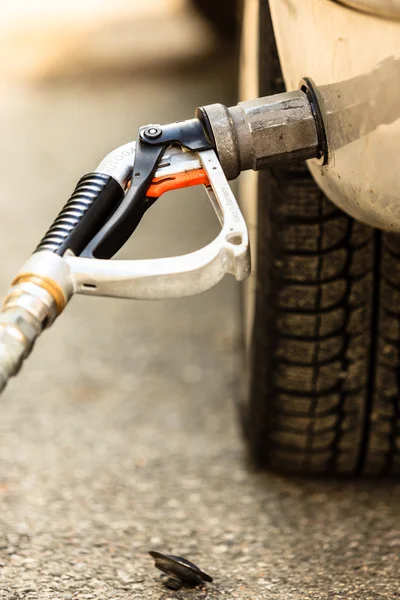 Car at gas station being filled with fuel — Stock Photo, Image