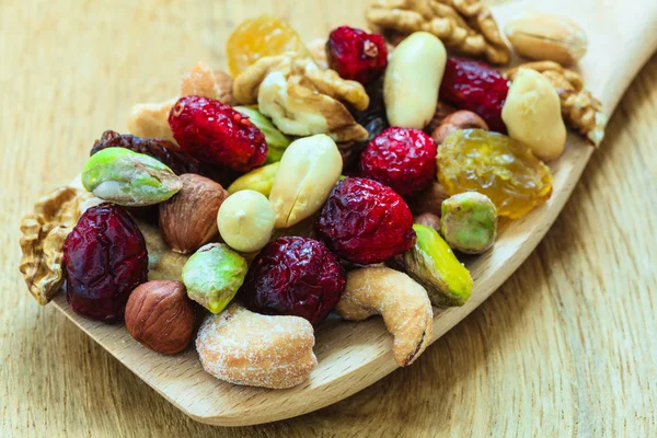 Dried fruits and nuts on spoon — Stock Photo, Image