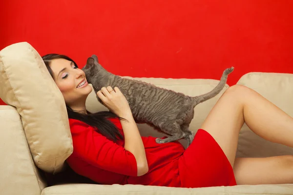 Pregnant woman playing with cat