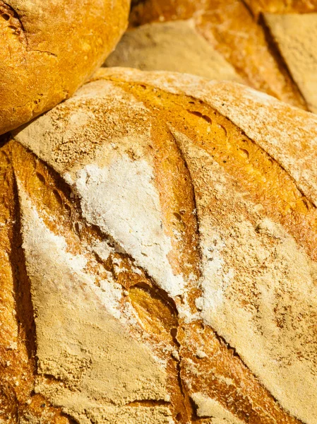 Many brown rustic fresh rye bread loaves as food background — Stock Photo, Image