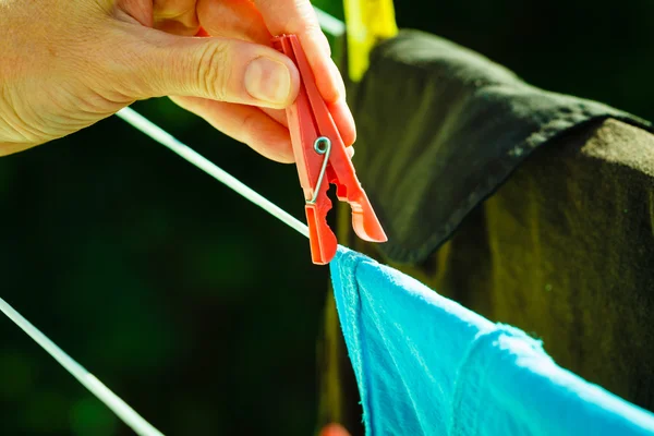 Mujer colgando ropa mojada en la línea de cuerda —  Fotos de Stock