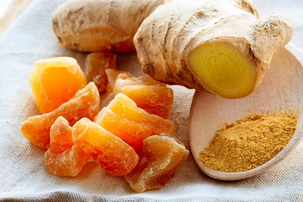 Candied fresh and ground ginger on rustic table — Stock Photo, Image