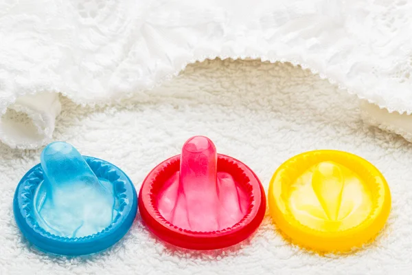 Condoms with lace lingerie — Stock Photo, Image