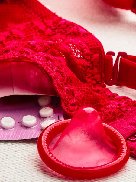 Pills, condom with lace lingerie. — Stock Photo, Image