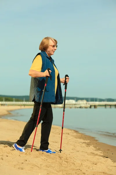 Nordic walking žena na pláži — Stock fotografie