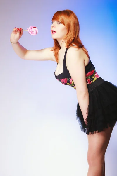 Redhair girl holding sweet food lollipop candy on blue. — Stock Photo, Image