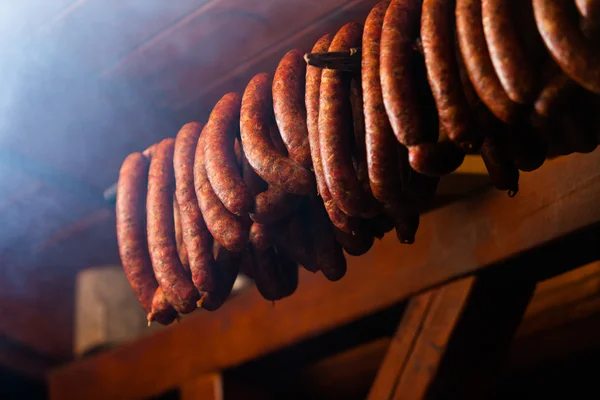 Traditional food. Smoked sausuages in smokehouse. — Stock Photo, Image