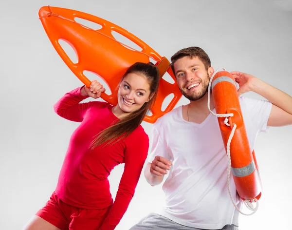 Lifeguards holding equipment