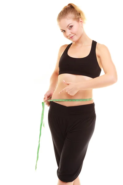 Blonde girl measuring waist Stock Photo