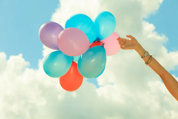 Hand holding balloons — Stock Photo, Image