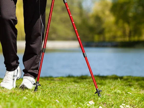 Nordic walking. Female legs hiking in the park. — Stock Photo, Image