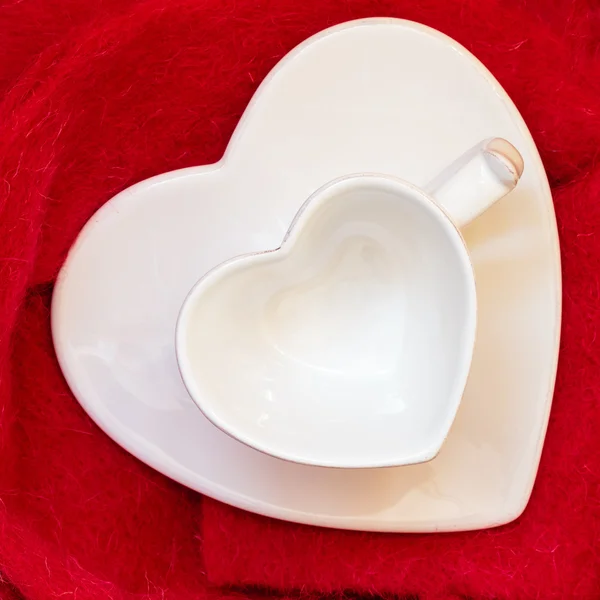 Empty heart shaped cup on red — Stock Photo, Image