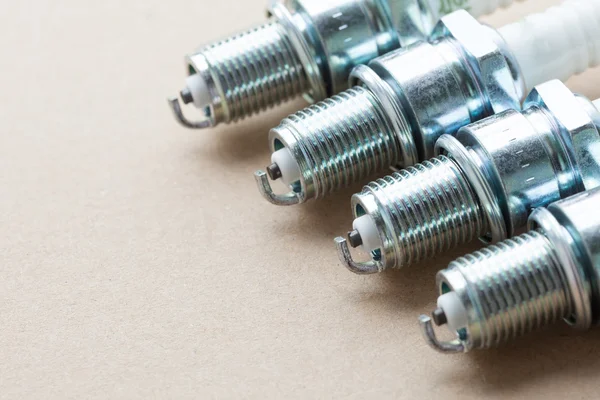 Auto service. Set of spark plugs as spare part of car. — Stock Photo, Image