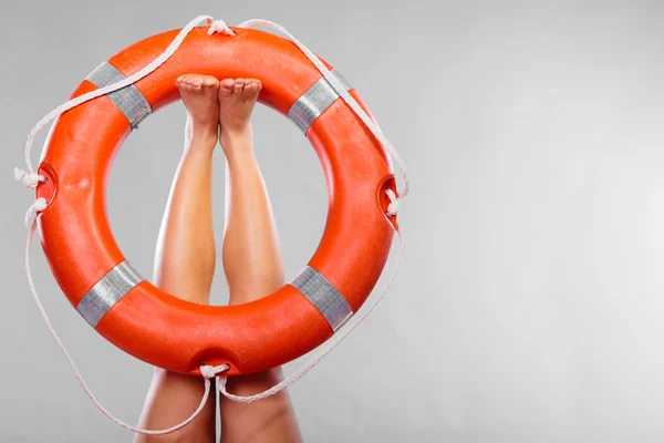 Life buoy ring on female legs — Stock Photo, Image