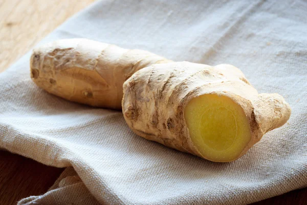 Closeup fresh raw ginger on rustic table — Stock Photo, Image