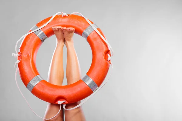 Life buoy ring on female legs — Stock Photo, Image