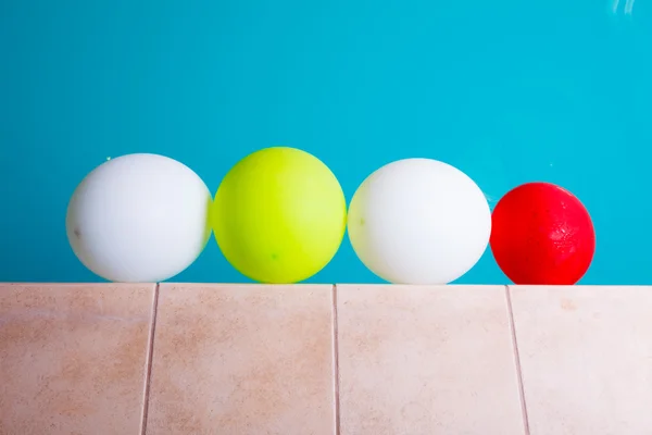 Colorful balloons in  swimming pool — Stock Photo, Image